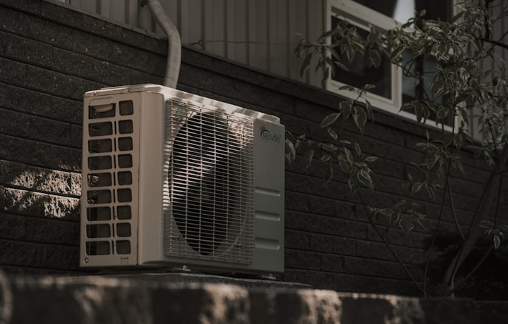 Outdoor air-conditioning condenser unit beside a home